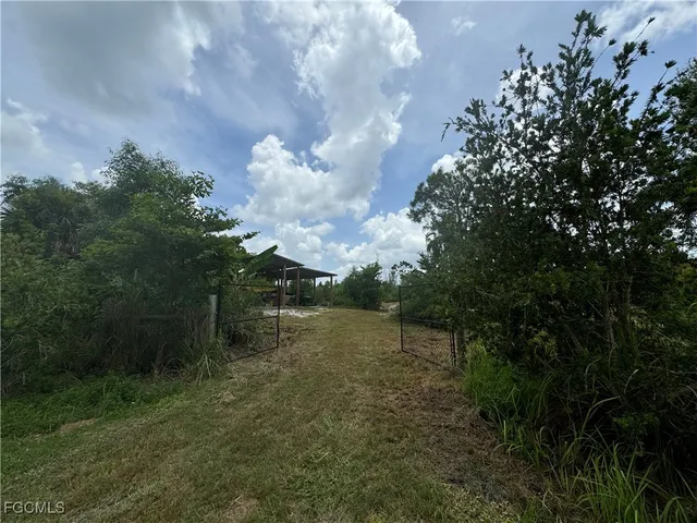 a small hut with trees in the background