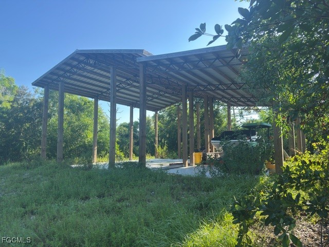 Island Ridge Road Bokeelia, FL 33922 - Photo 8 of 10 a view of a backyard with couches plants and large trees