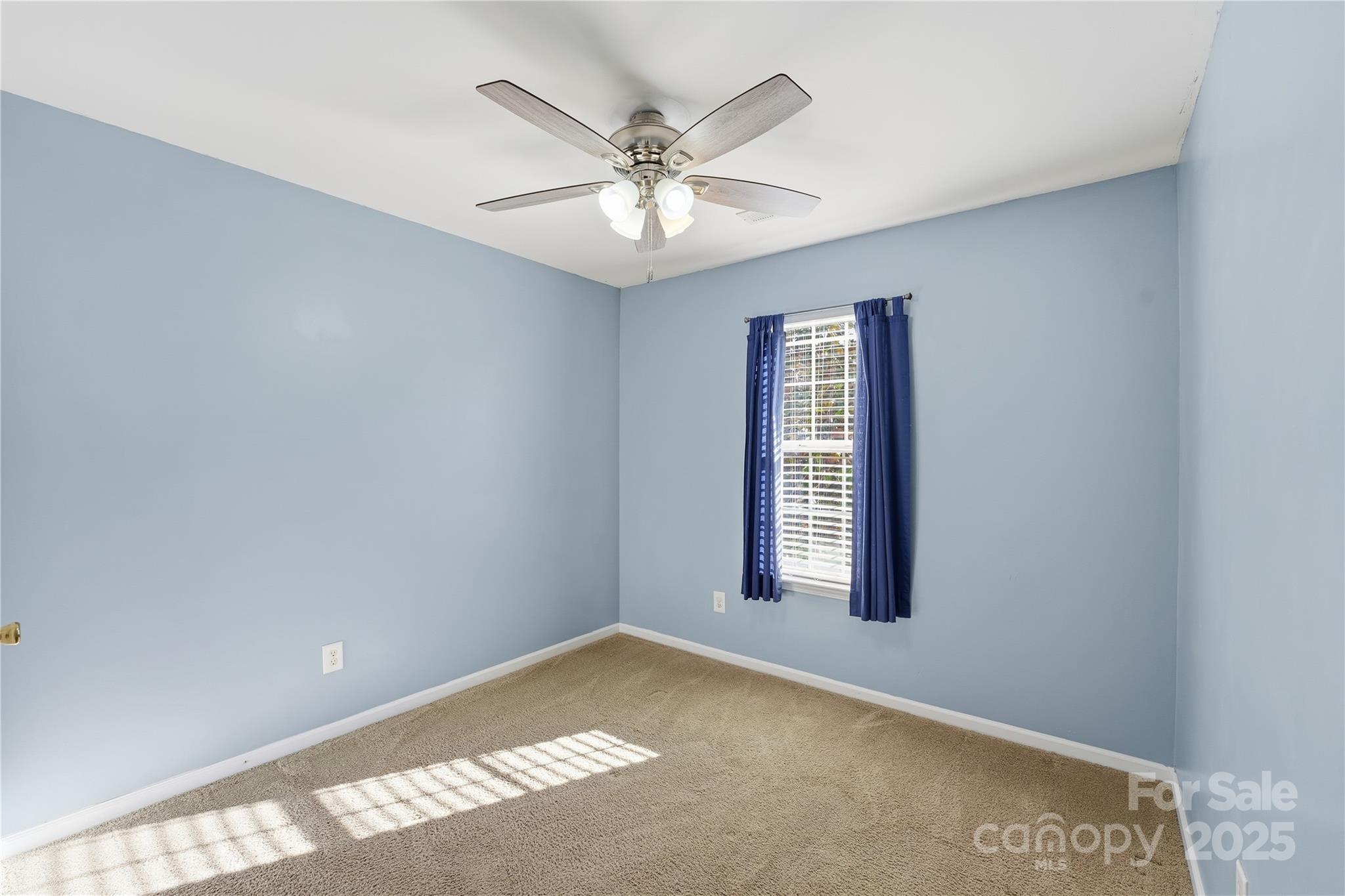 5822 Meeting Street Concord, NC 28025 - Photo 15 of 21 an empty room with windows and ceiling fan