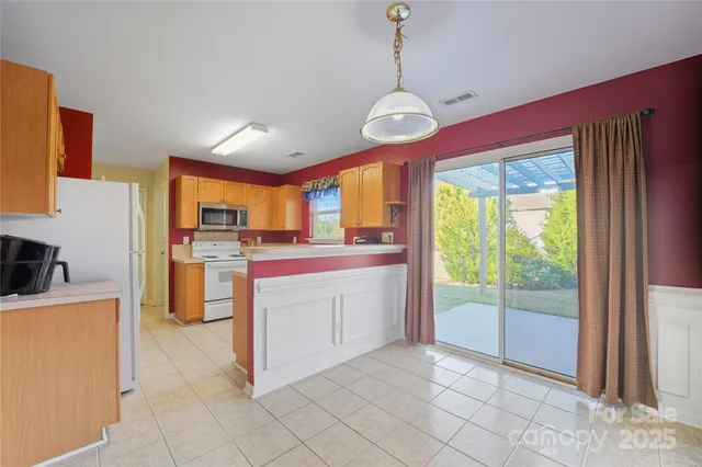 a open kitchen with cabinets a stove and a refrigerator