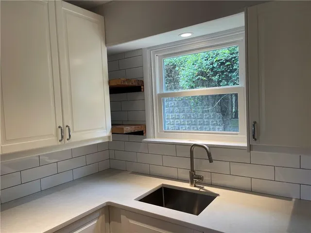 a kitchen with a sink and cabinets