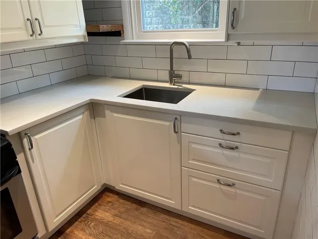 a close view of a sink and dishwasher in a kitchen