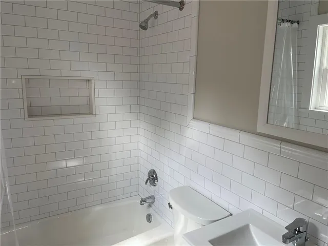 a bathroom with a sink a toilet and bathtub