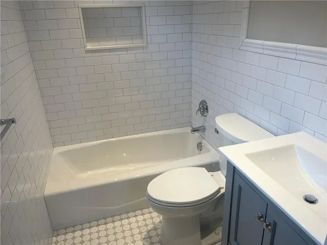 a view of a hallway with wooden floor and front door