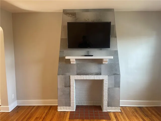 a living room with a fireplace and a wooden floor