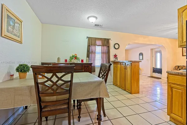 a dining room with furniture and window