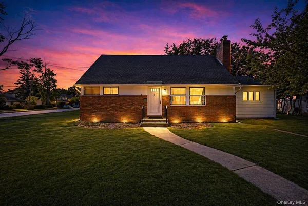 a front view of a house with a garden
