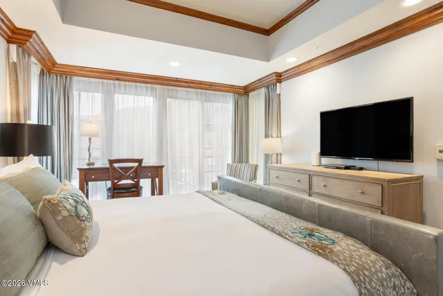 a bedroom with furniture and a flat screen tv