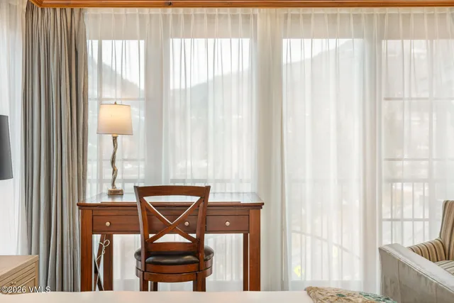 a view of a balcony with chair and floor to ceiling window