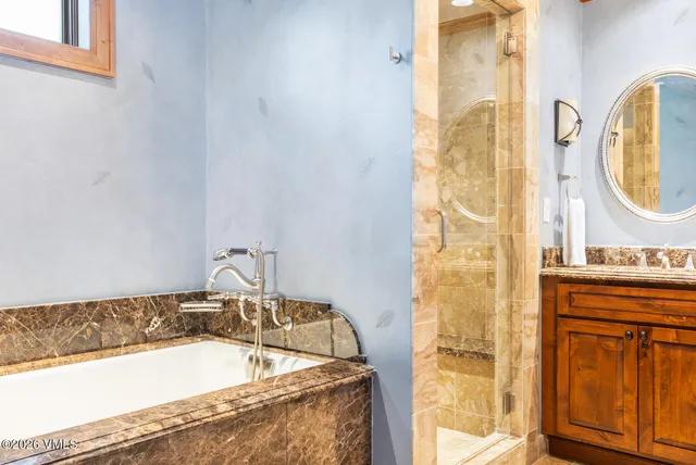 a bathroom with a tub and a sink