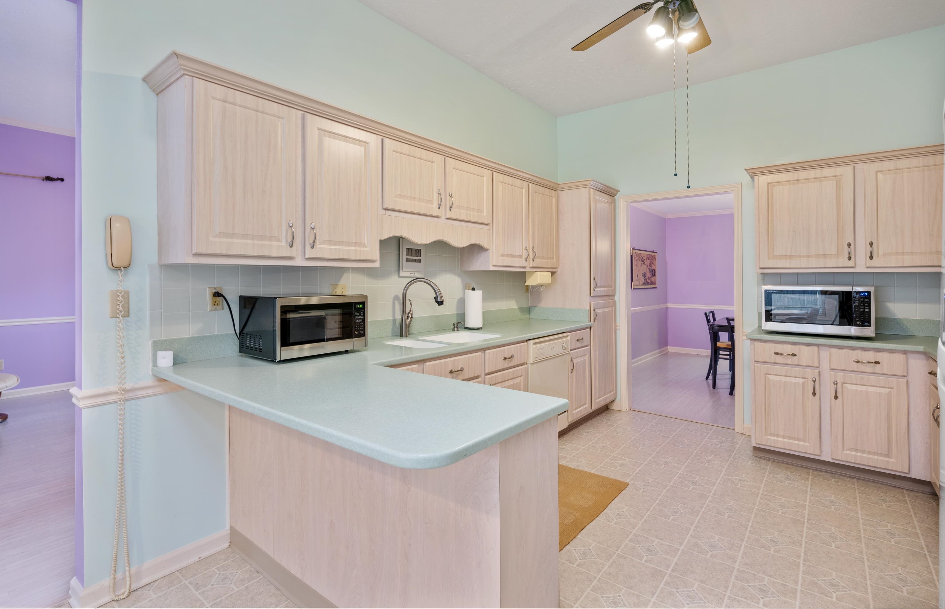 811 Vaughn Road Memphis, TN 38122 - Photo 13 of 33 a kitchen with kitchen island granite countertop white cabinets stainless steel appliances and a sink