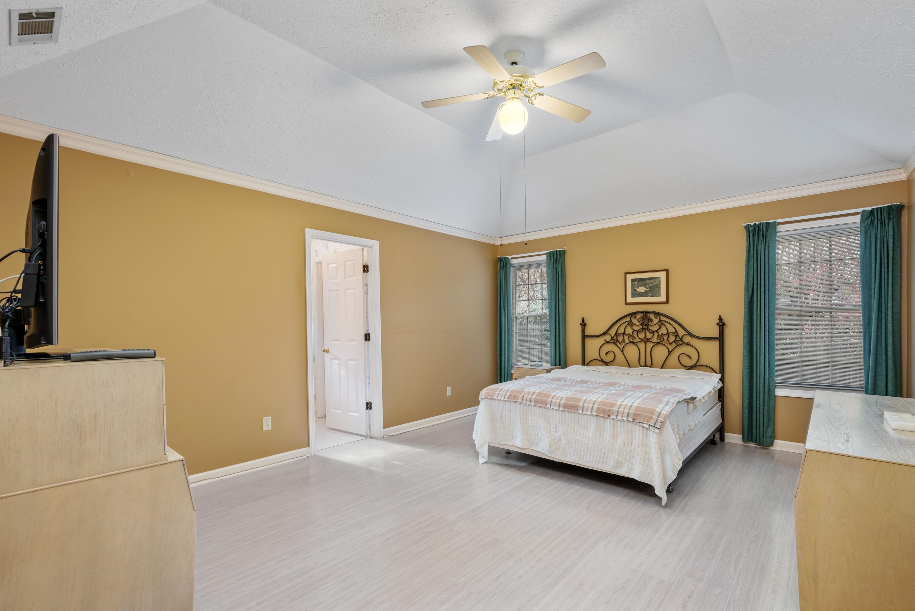 811 Vaughn Road Memphis, TN 38122 - Photo 15 of 33 a bedroom with a bed and a chandelier