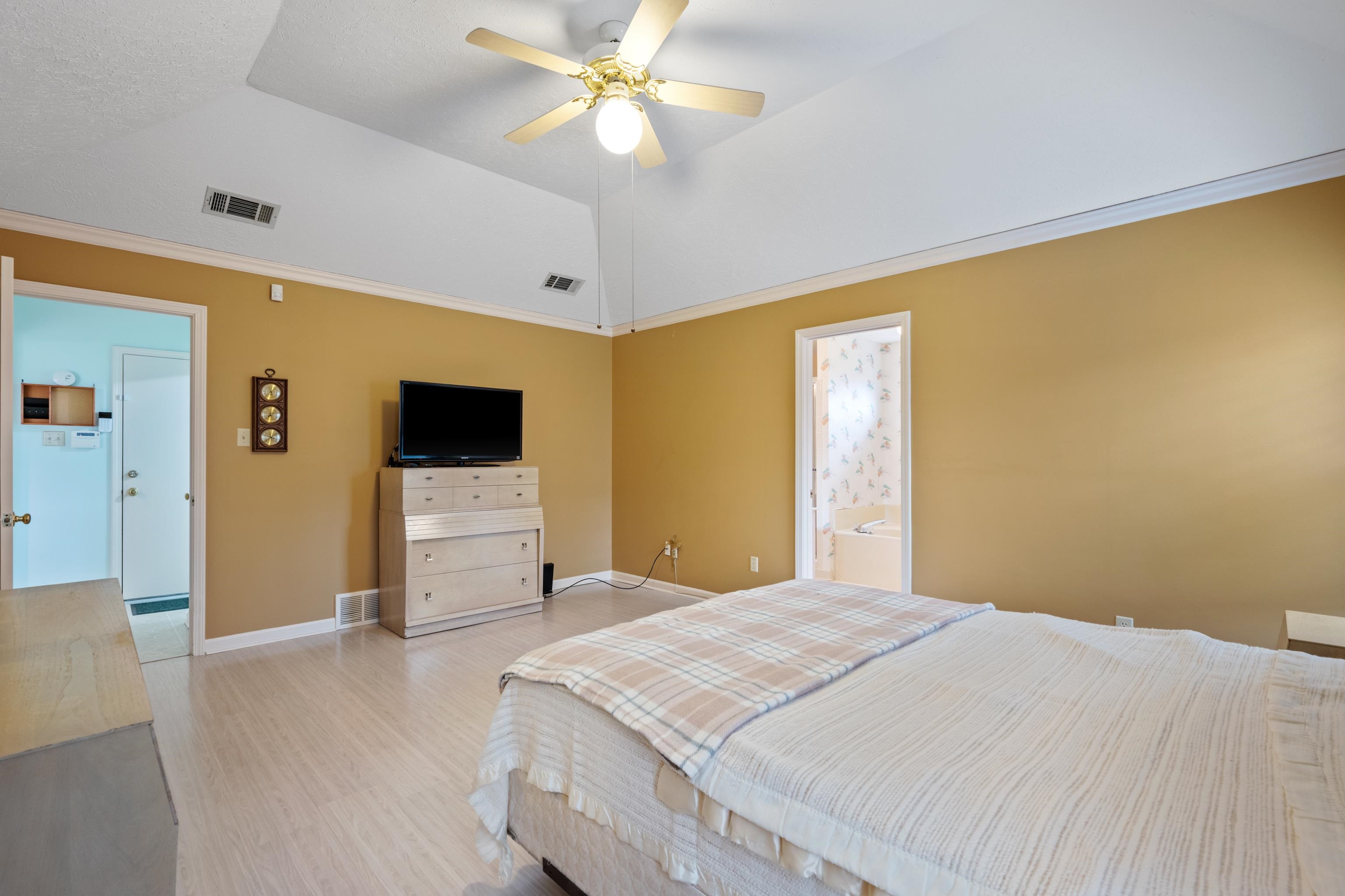 811 Vaughn Road Memphis, TN 38122 - Photo 16 of 33 a bedroom with a large bed a flat tv screen and dresser