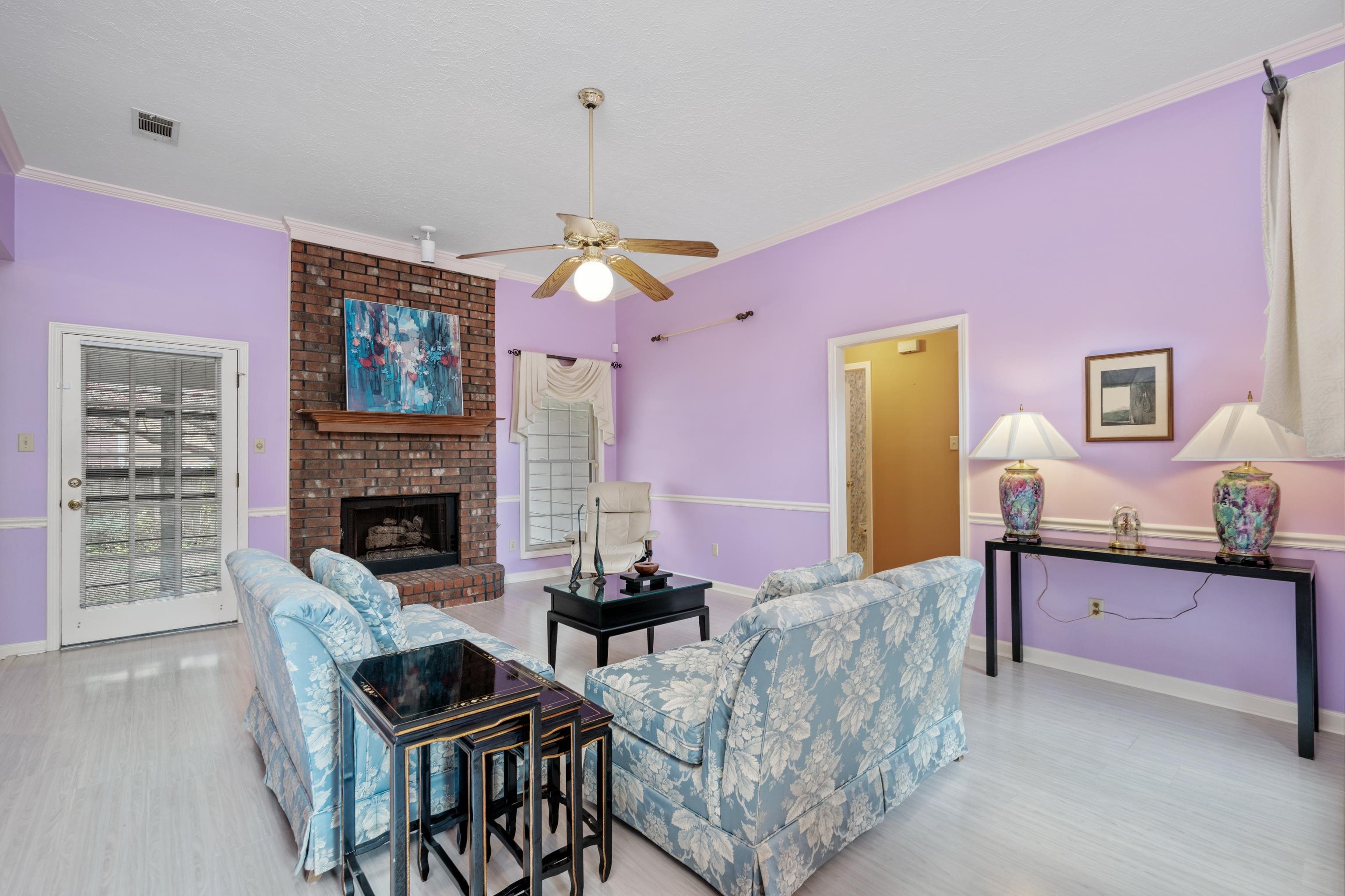 811 Vaughn Road Memphis, TN 38122 - Photo 19 of 33 a living room with furniture a fireplace and a flat screen tv