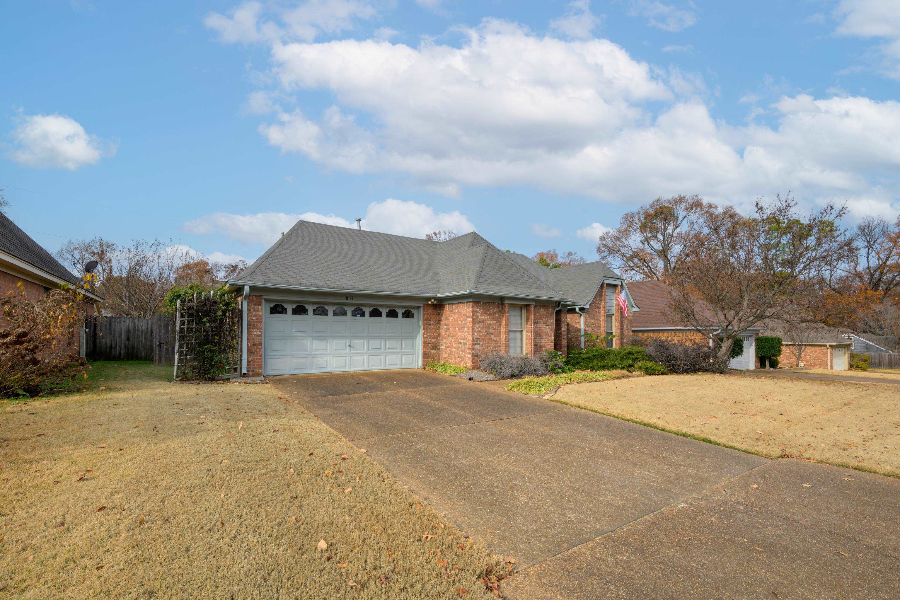 811 Vaughn Road Memphis, TN 38122 - Photo 2 of 33 a front view of a house with a yard and garage