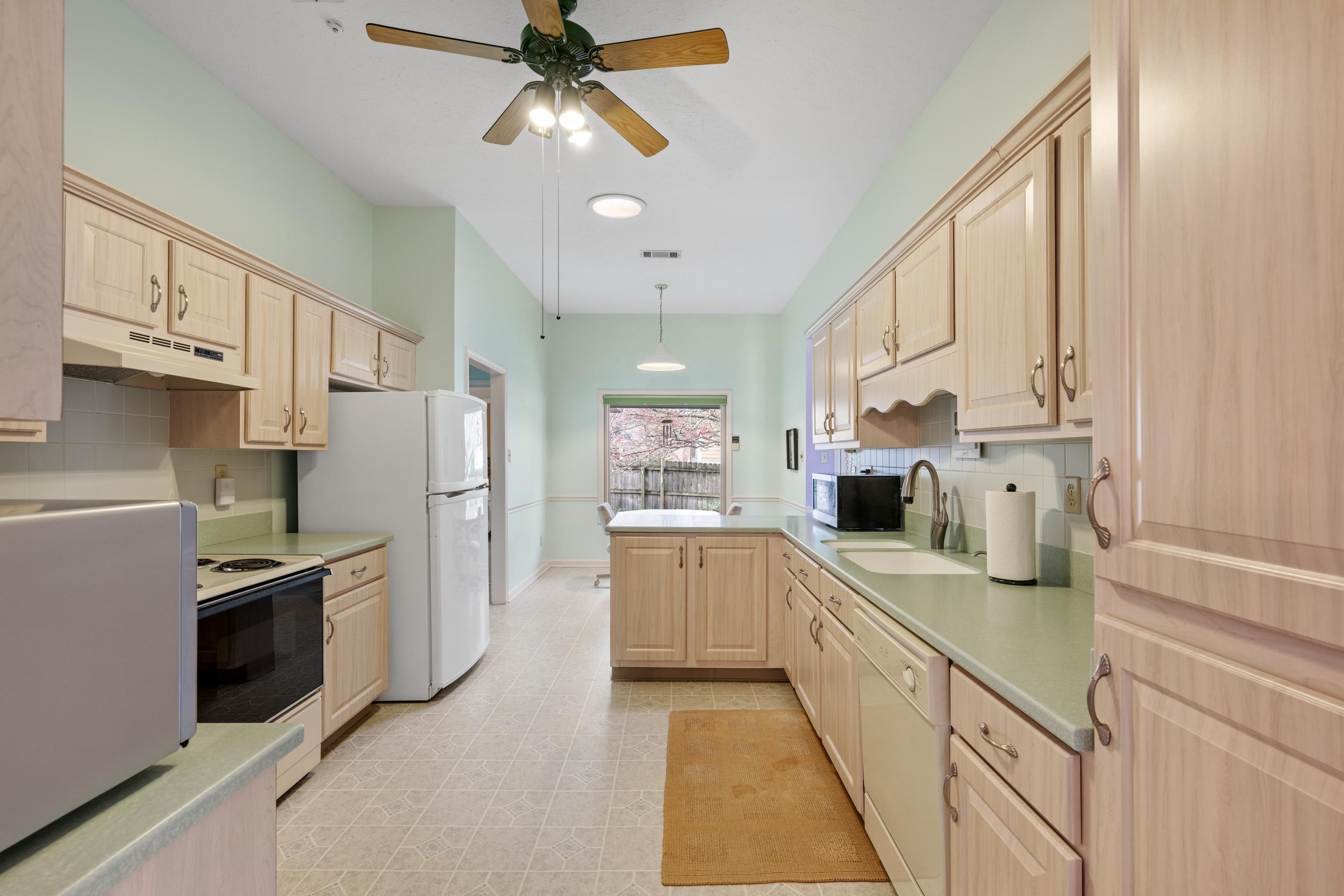 811 Vaughn Road Memphis, TN 38122 - Photo 9 of 33 a kitchen with stainless steel appliances a sink a stove a refrigerator cabinets and a window