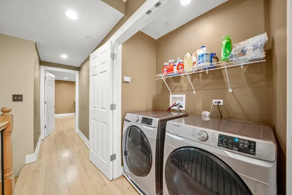 a view of washer and dryer with kitchen in the background