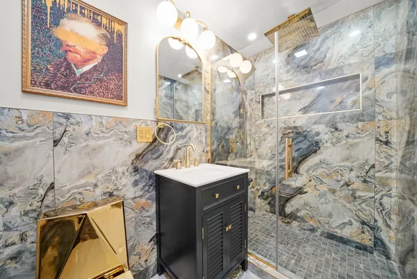 a bathroom with a sink mirror and vanity