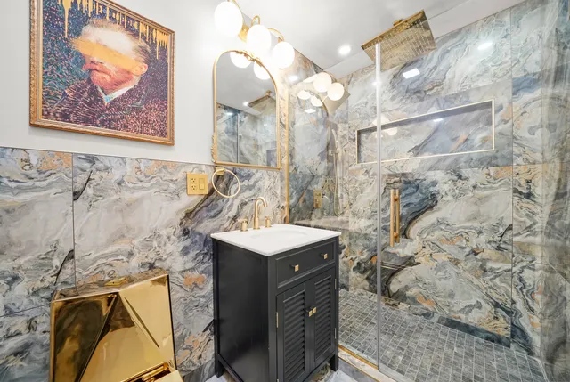 a bathroom with a sink mirror and vanity