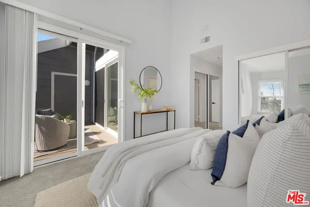 a bedroom with a bed and a mirror