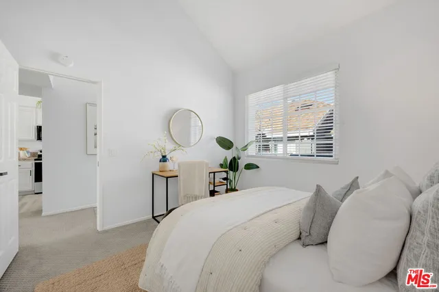 a living room with furniture a window and a potted plant