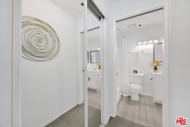 a bathroom with a granite countertop toilet and a sink