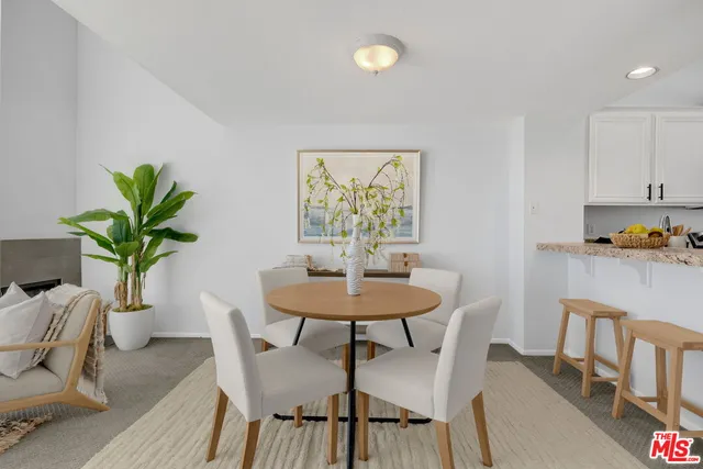 a view of a dining room with furniture and a potted plant