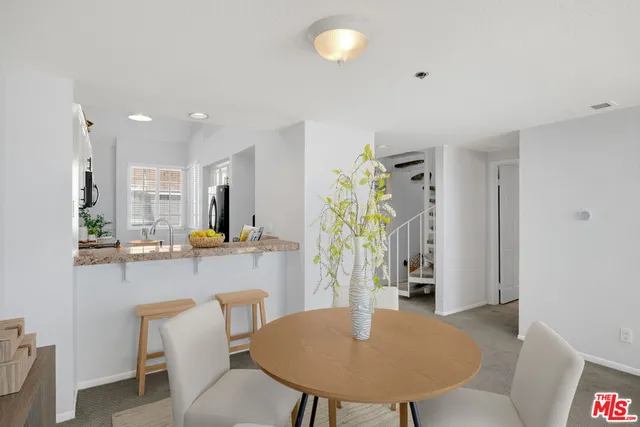 a kitchen with a table and chairs in it