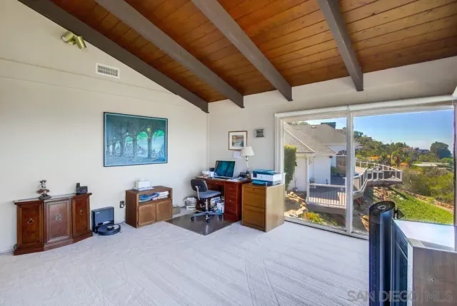 a living room with furniture fireplace and a large window