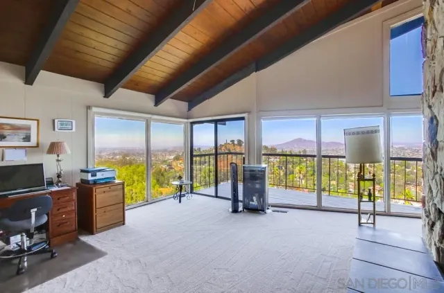 a view of a balcony with wooden floor and fence