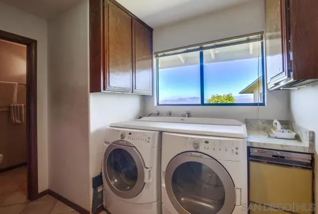 a room with two beds and a large window