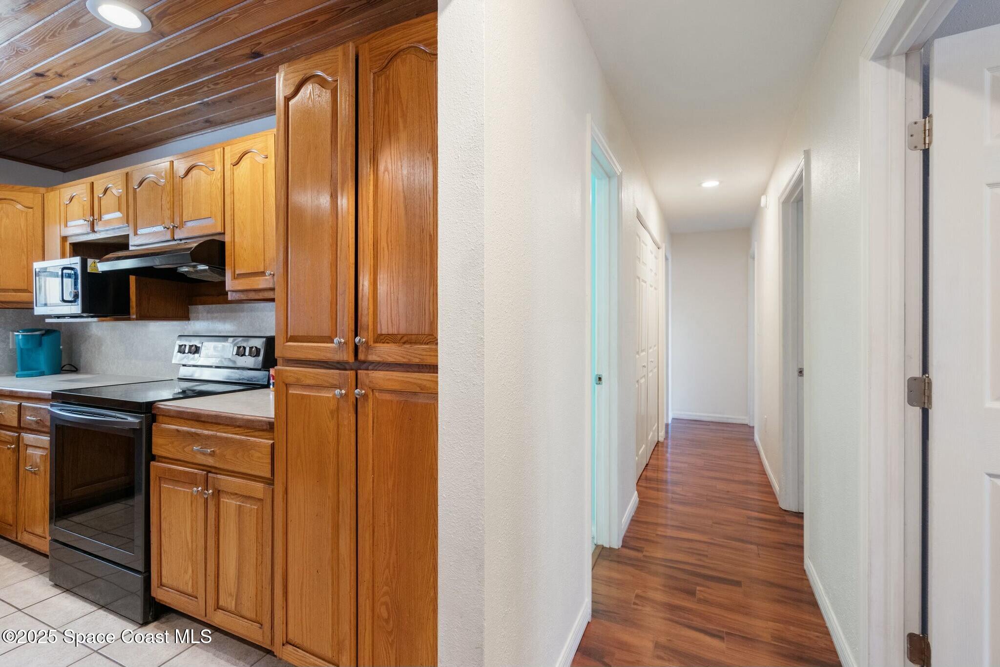 1550 Creel Road Northeast Palm Bay, FL 32905 - Photo 13 of 27 a view of a kitchen from the hallway