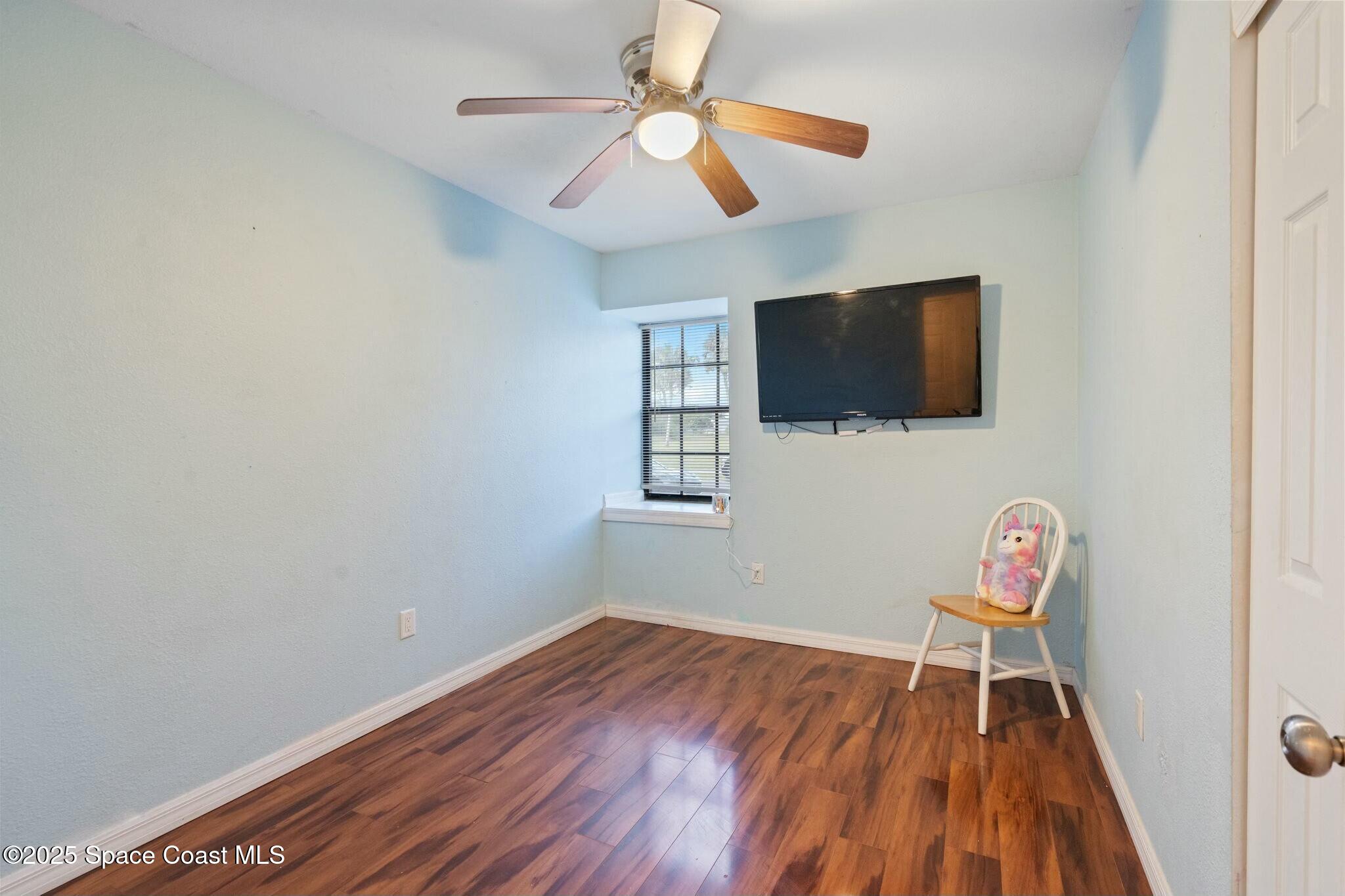 1550 Creel Road Northeast Palm Bay, FL 32905 - Photo 16 of 27 a view of room with workspace and wooden floor