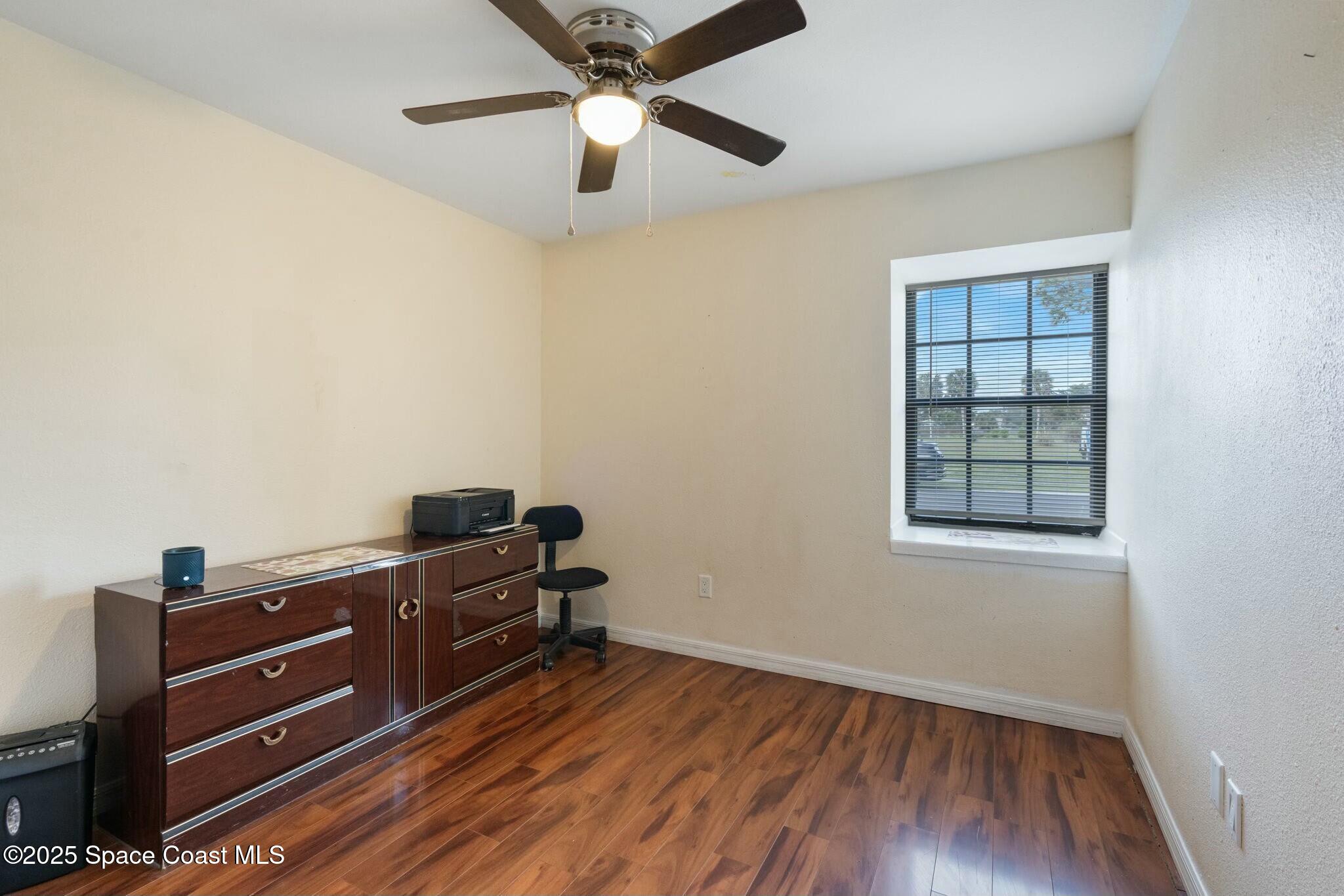 1550 Creel Road Northeast Palm Bay, FL 32905 - Photo 17 of 27 a view of a workspace with furniture and a window