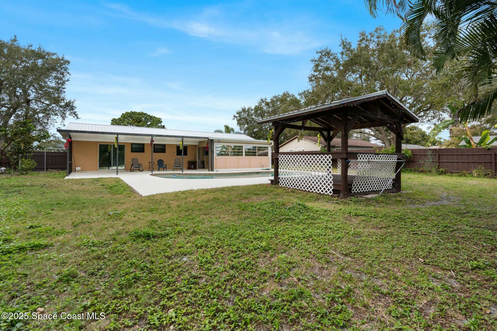 1550 Creel Road Northeast Palm Bay, FL 32905 - Photo 23 of 27 a view of a house with a yard balcony and sitting area