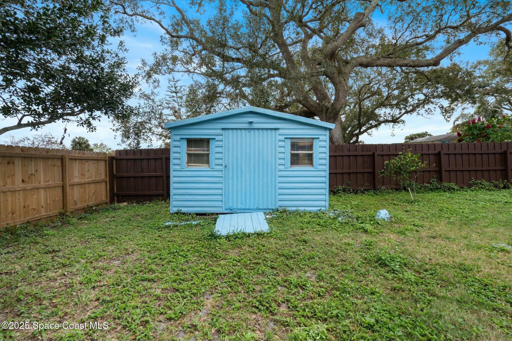 1550 Creel Road Northeast Palm Bay, FL 32905 - Photo 24 of 27 a backyard of a house with lots of green space