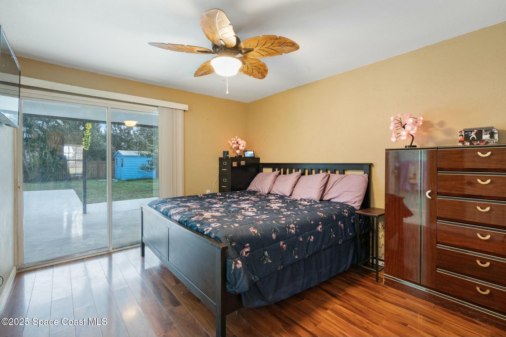 1550 Creel Road Northeast Palm Bay, FL 32905 - Photo 9 of 27 a bed sitting in a bedroom next to a window