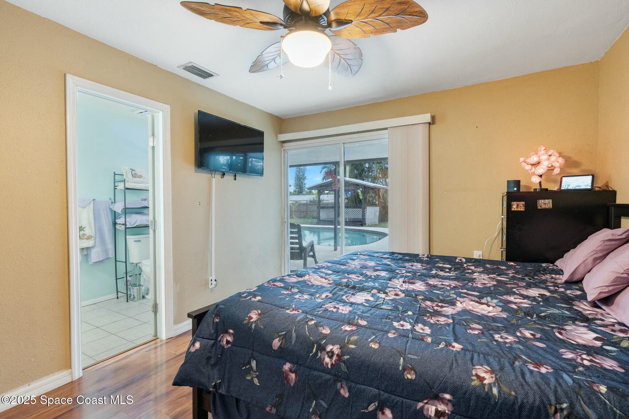 1550 Creel Road Northeast Palm Bay, FL 32905 - Photo 10 of 27 a bedroom with a large bed and a window