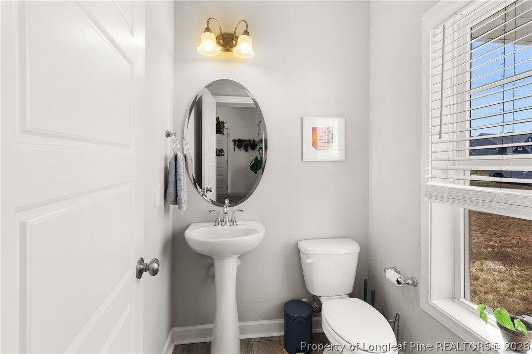 84 Rainy Beck Way Erwin, NC 28339 - Photo 19 of 36 a bathroom with a toilet sink and mirror