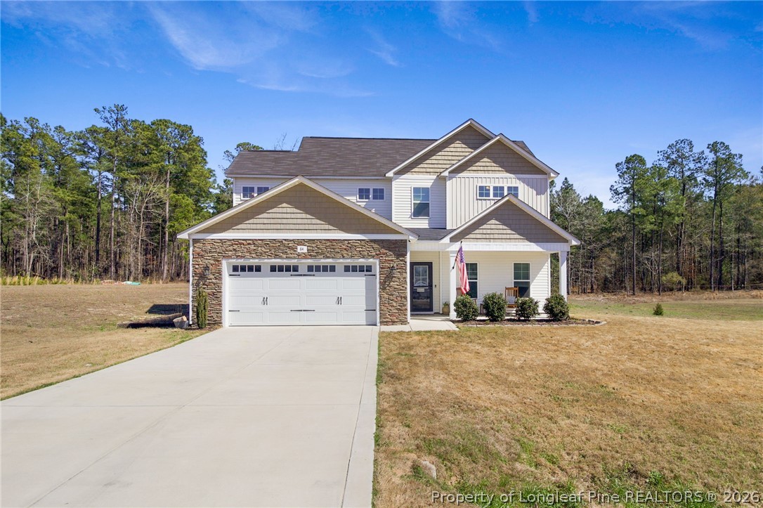 84 Rainy Beck Way Erwin, NC 28339 - Photo 2 of 36 a view of a house with a yard and large trees