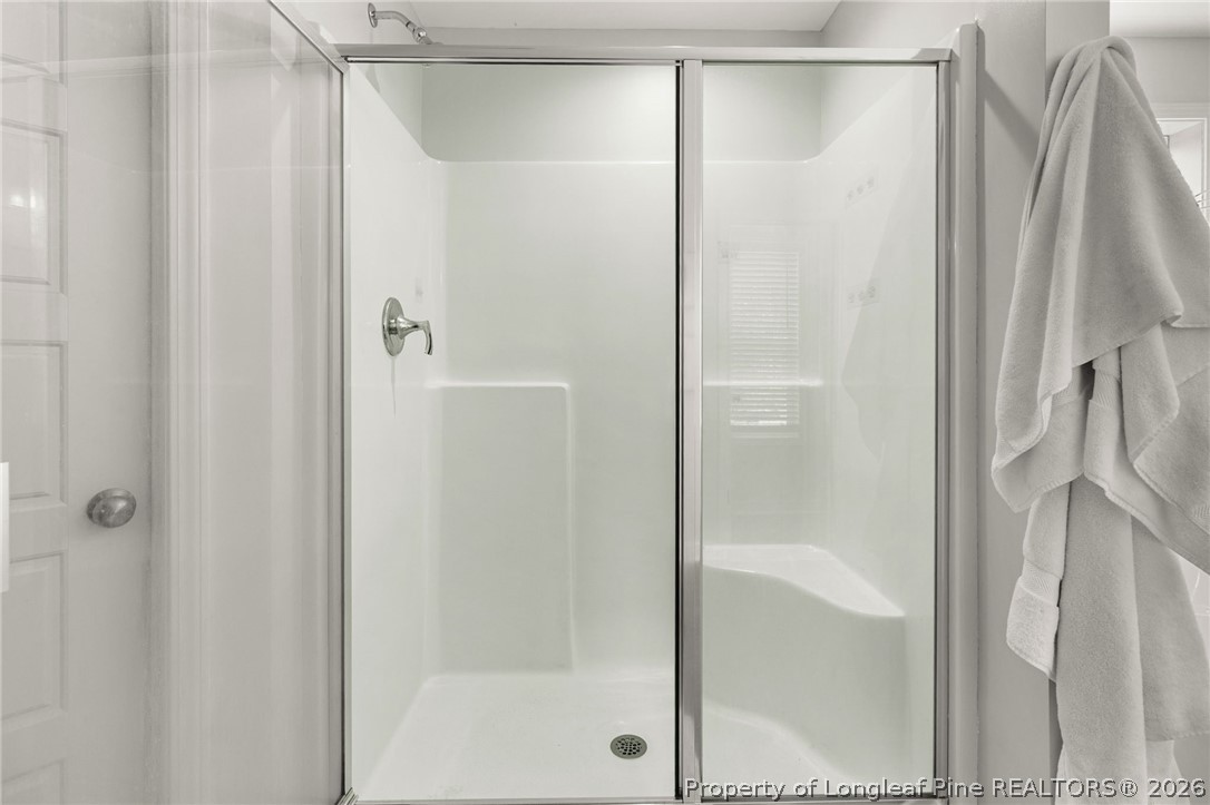 84 Rainy Beck Way Erwin, NC 28339 - Photo 23 of 36 a bathroom with a glass shower door