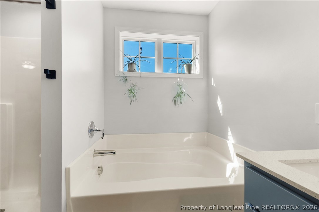 84 Rainy Beck Way Erwin, NC 28339 - Photo 25 of 36 a bath tub sitting next to a white sink