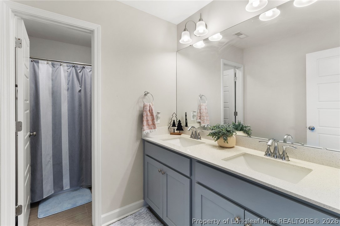 84 Rainy Beck Way Erwin, NC 28339 - Photo 28 of 36 a bathroom with a sink double vanity and a mirror