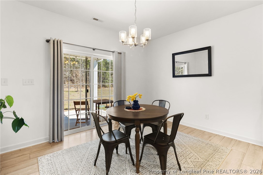 84 Rainy Beck Way Erwin, NC 28339 - Photo 6 of 36 a view of a dining room with furniture and chandelier