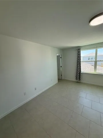 an empty room with a empty space and windows