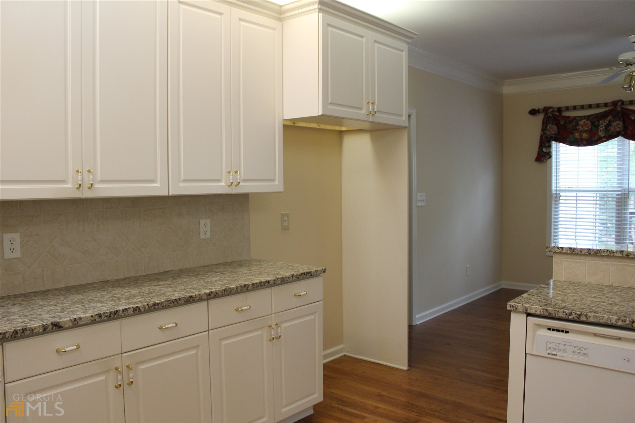 149 Walnut Ridge Drive Hoschton, GA 30548 - Photo 7 of 19 a kitchen with granite countertop white cabinets and a sink