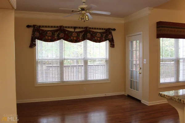 a view of a bedroom with a bed and a window