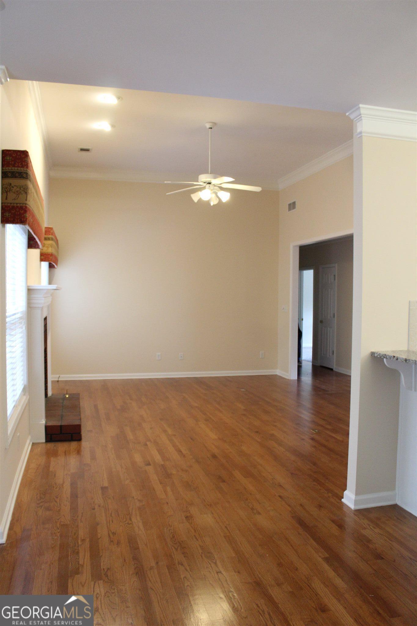 149 Walnut Ridge Drive Hoschton, GA 30548 - Photo 10 of 19 a view of a room with wooden floor and a staircase
