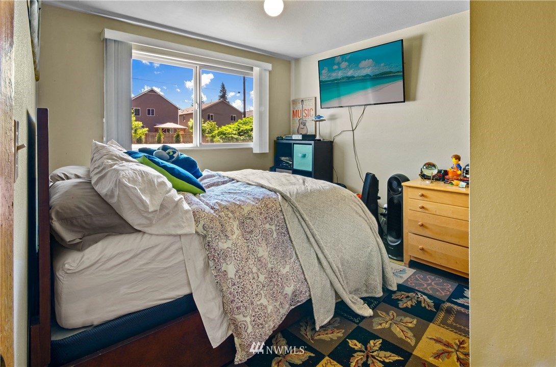 4117 212th Street Southeast Bothell, WA 98021 - Photo 16 of 32 a bed sitting in a bedroom next to a window