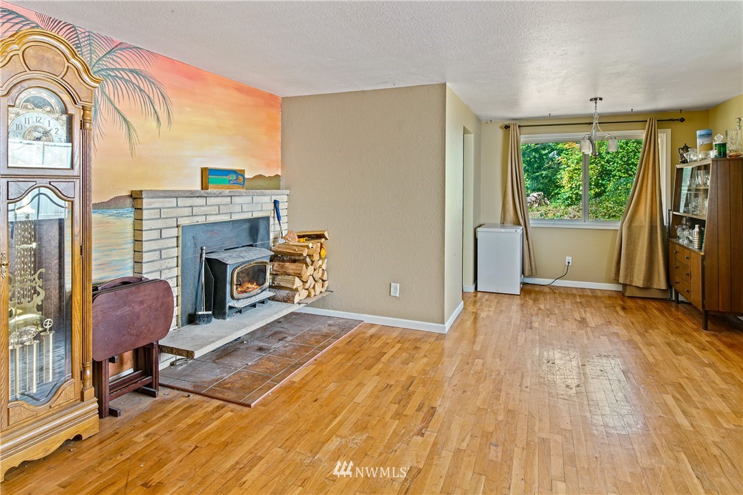 4117 212th Street Southeast Bothell, WA 98021 - Photo 6 of 32 a view of livingroom with furniture a fireplace and wooden floor